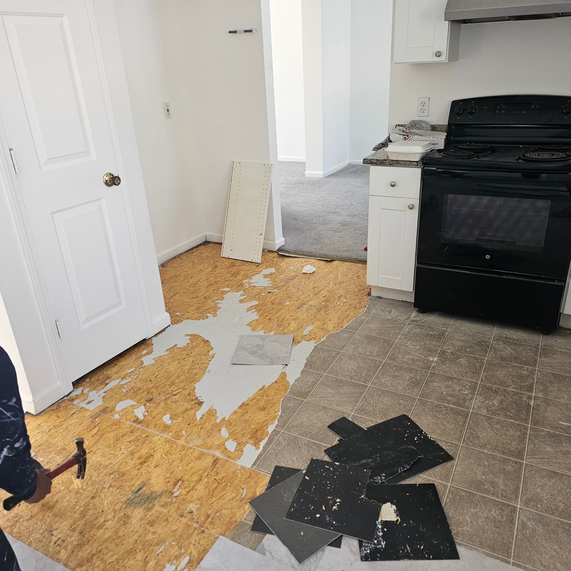 Before — peeling tile and damaged subfloor